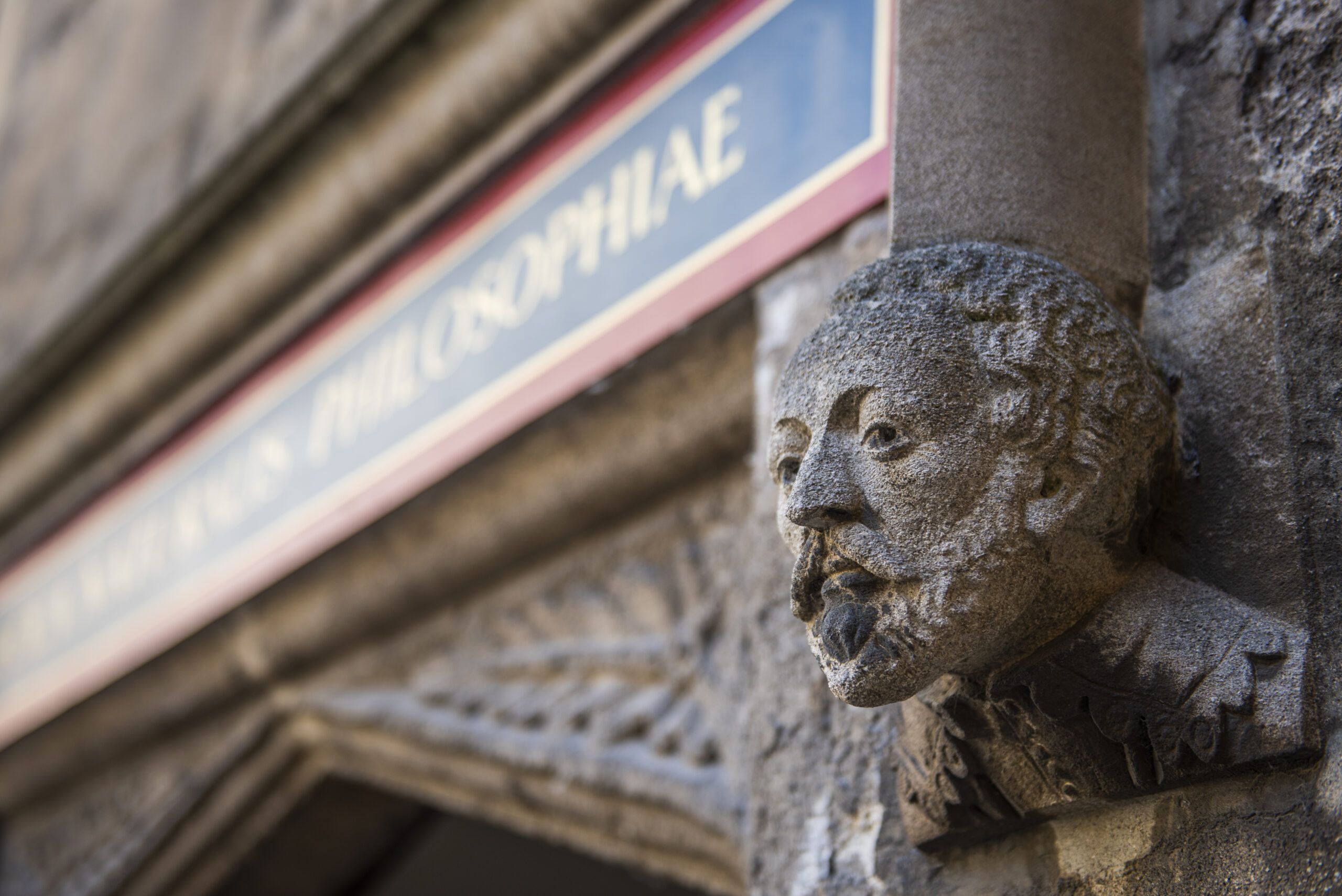 Close up of department of philosophy building, Oxford University - historical figure head carved in stone 