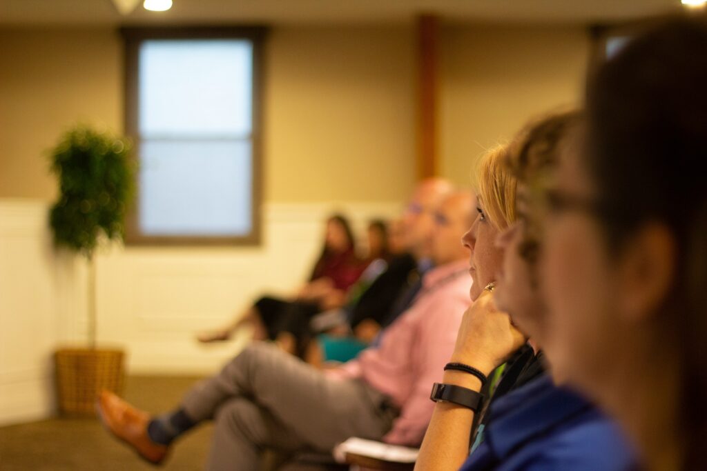 Group of adults watching a lecture 